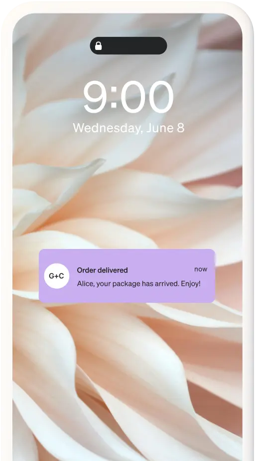 A push notification on a mobile phone that reads: "Order delivered. Alice, your package has arrived. Enjoy!"