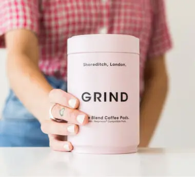 Close-up of a canister of Grind coffee pods