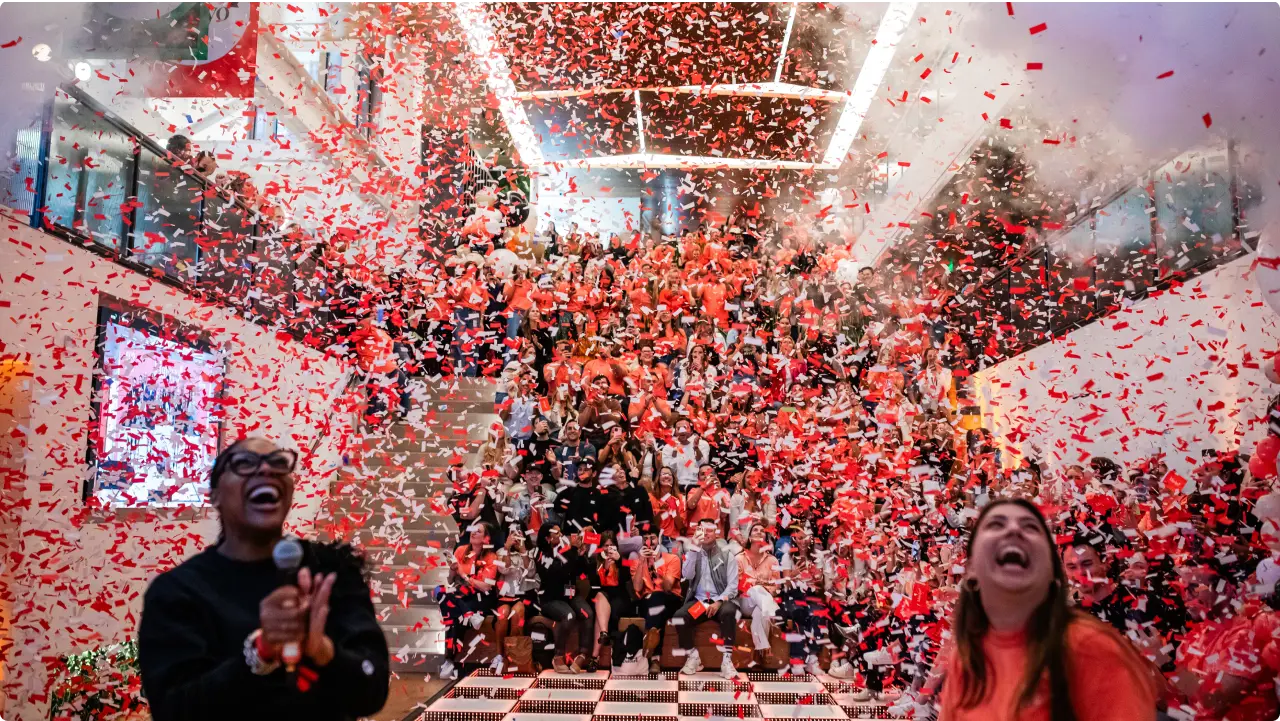 A joyous celebration in the atrium of Klaviyo's Boston headquarters, the room filled with joyous employees and a thick cloud of confetti.
