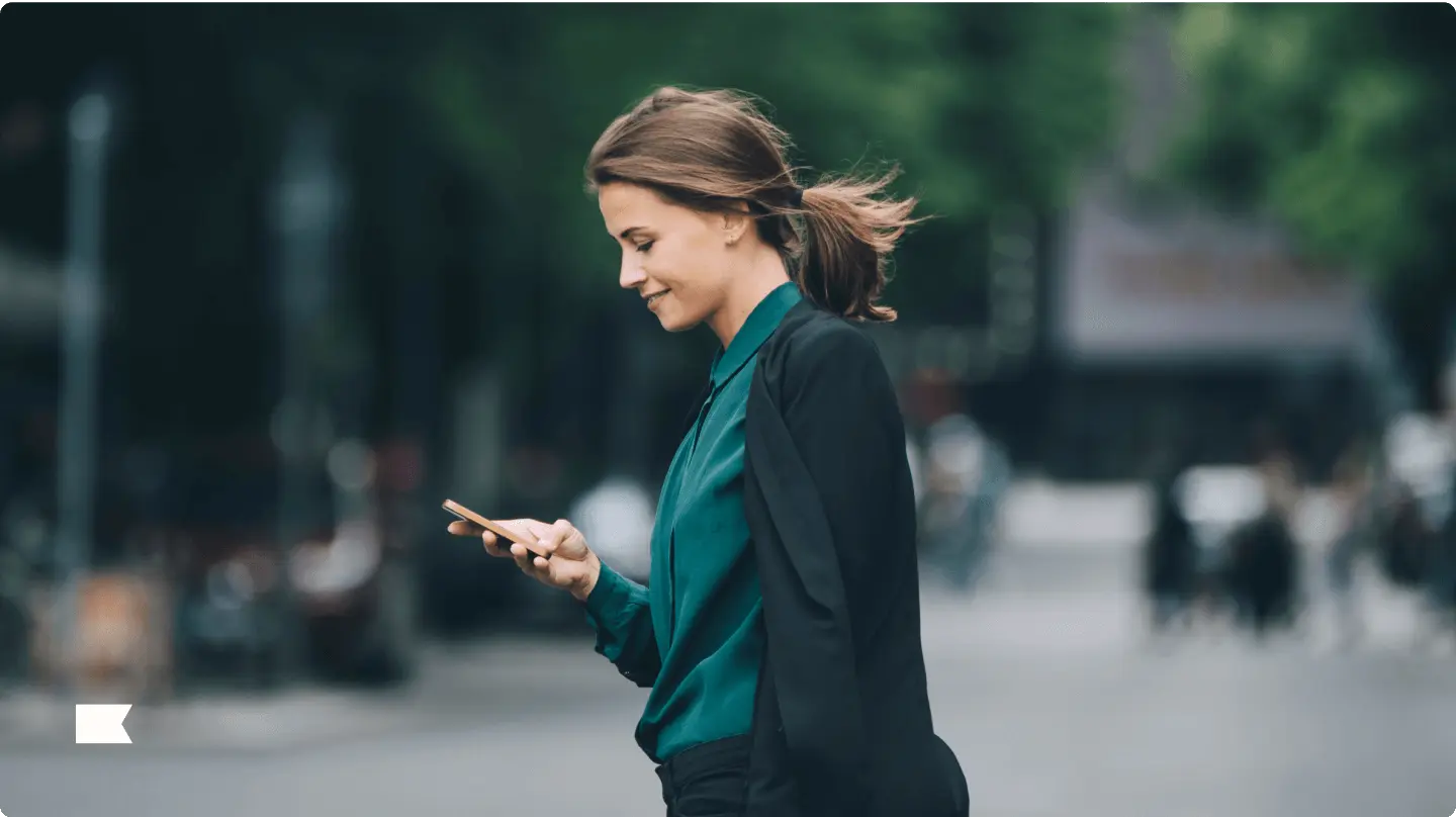 person walking and looking at phone